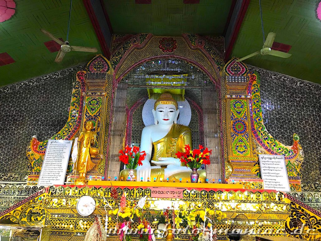 Ein Buddha thront in der Su Taung Pyae Pagode in all der Farbenpracht