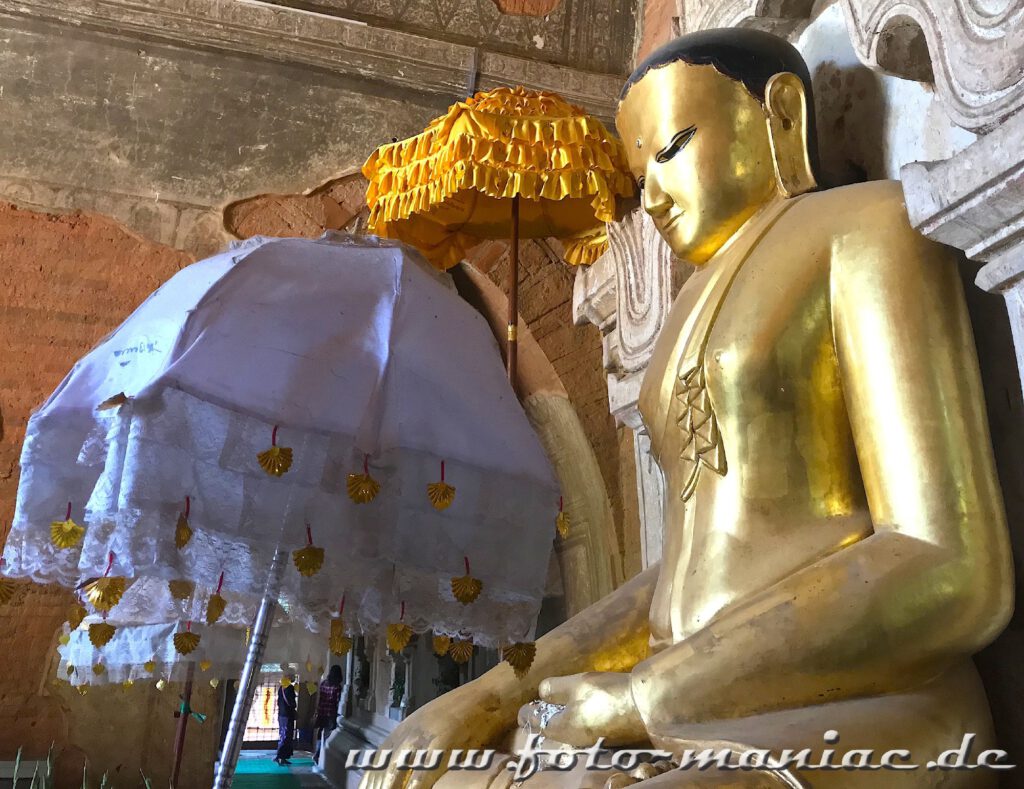 Tempel-Hopping in Bagan - Goldener Buddha mit Ehrenschirmen im Htilominlo Tempel