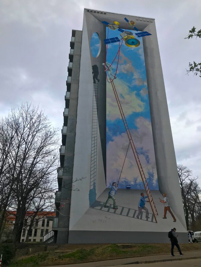 Graffito zeigt Männer mit Leiter